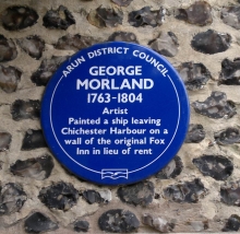 A plaque commemorating the fact that the painter George Morland painted a picture of a ship on the wall of the Fox Inn in lieu of rent.